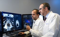 Dr. Daniel Costa, left, and Dr. Ivan Pedrosa, right, review multiparametric MRI...