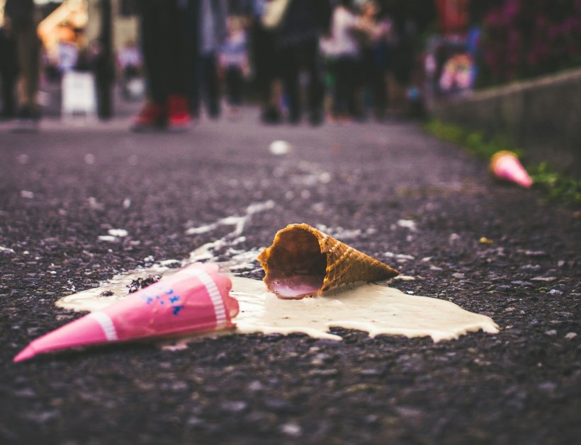 molten ice cream cone on asphalt road
