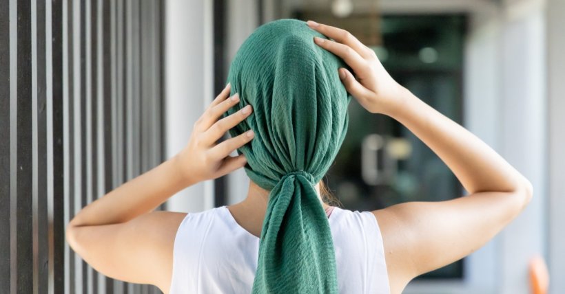 woman wearing green head scarf after cancer chemotherapy