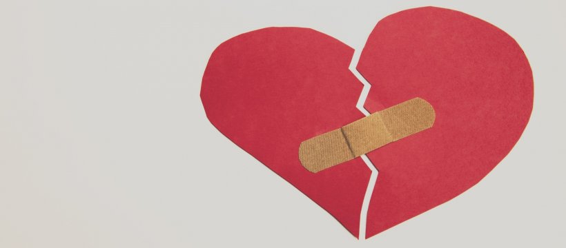 cutout paper heart fixed with band-aid