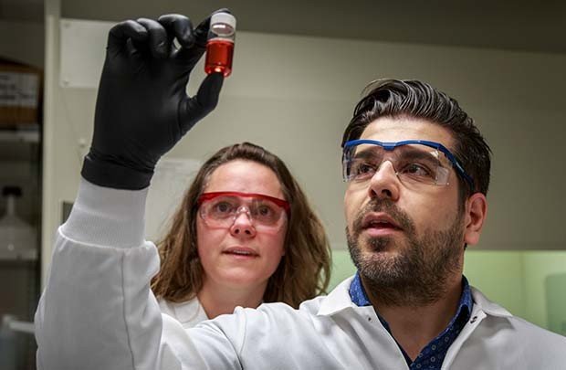 Drs. Jen Adair (left) and Reza Shahbazi examine a test batch of gold...