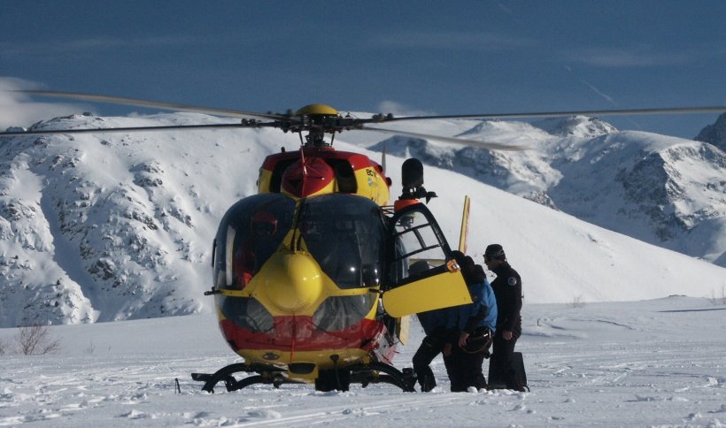helicopter on the ground in snowy alpine landscape