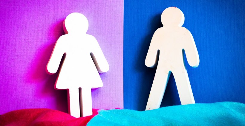 white woman and man silhouette cutouts in front of pink and blue background