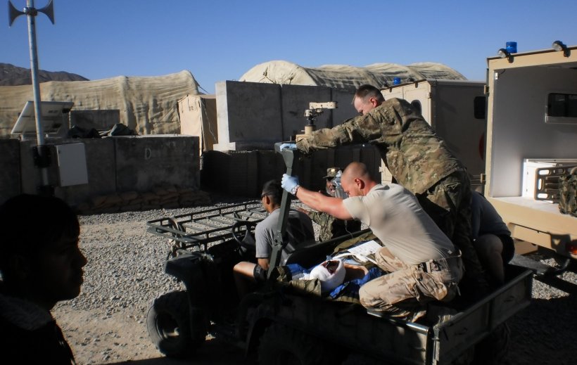 Martin Oberreiter on a medical vehicle in Afghanistan with a wounded patient