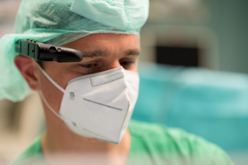 man wearing surgery cap and head mounted display