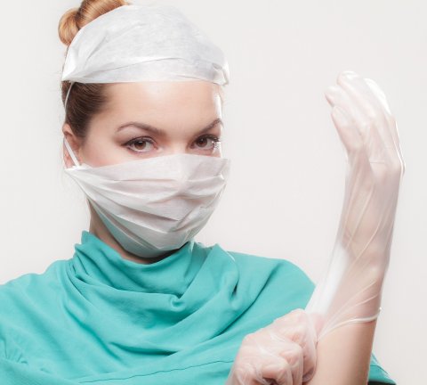 female surgeon wearing mask and glove