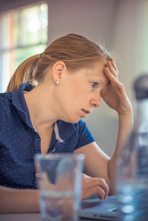 worried woman sitting at a table