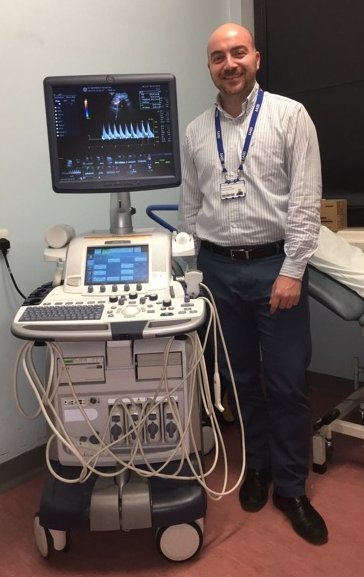 Fabrizio d’Abate standing next to an ultrasound device