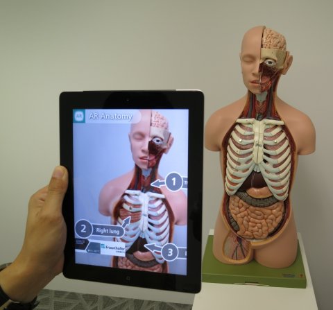human anatomy model seen though a tablet computer with augmented reality software