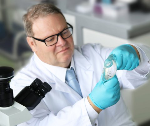 scientist holding faulty breast implant