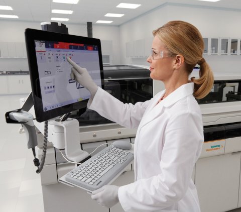woman in a laboratory operating a touchscreen
